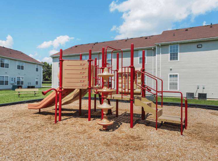 Playground with wood chips in court yard between buildings